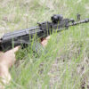 UltiMAK M7-B Optic Mount on AMD-65, woman aiming prone in grass